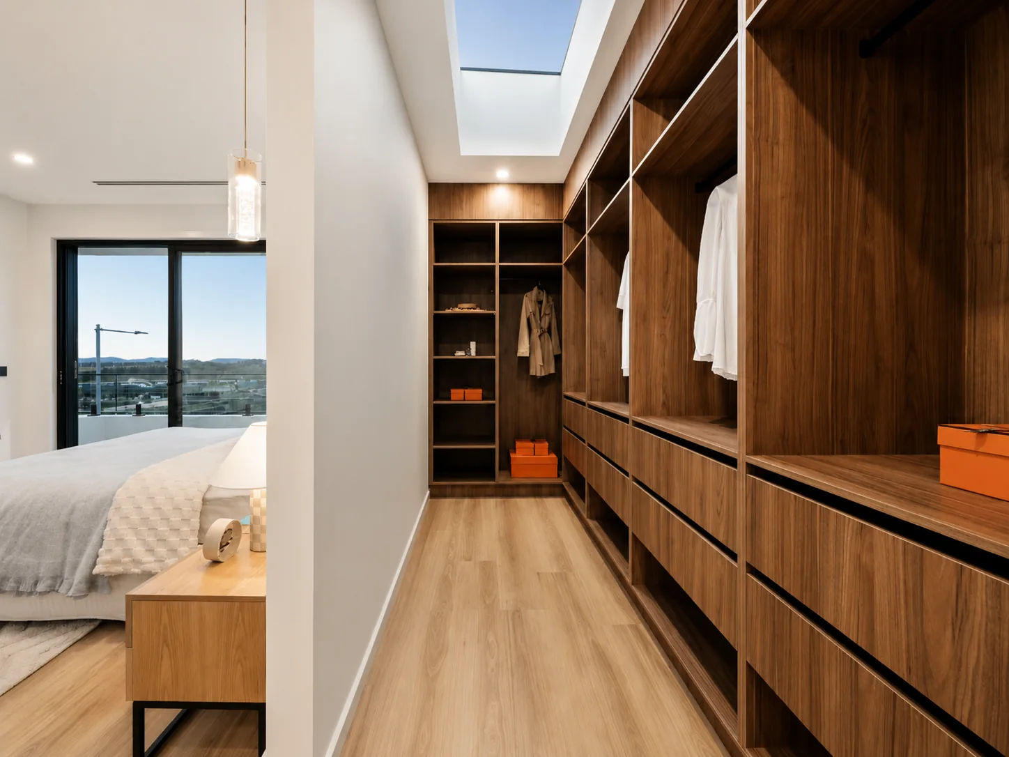 Timber walk-in wardrobe joinery beside a bedroom