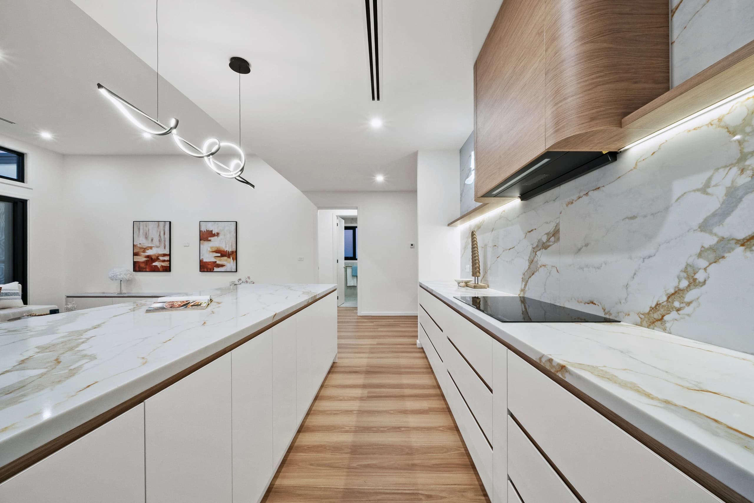 Warm residential kitchen with a stone island and timber cabinetry