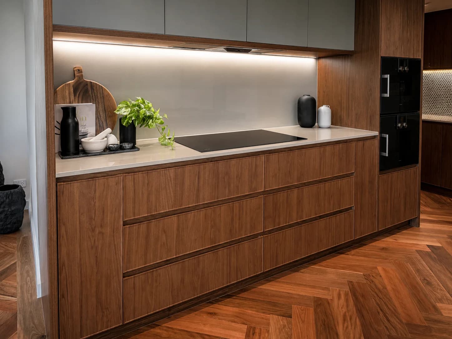 Timber drawer fronts, stone surface and recessed cabinetry detail